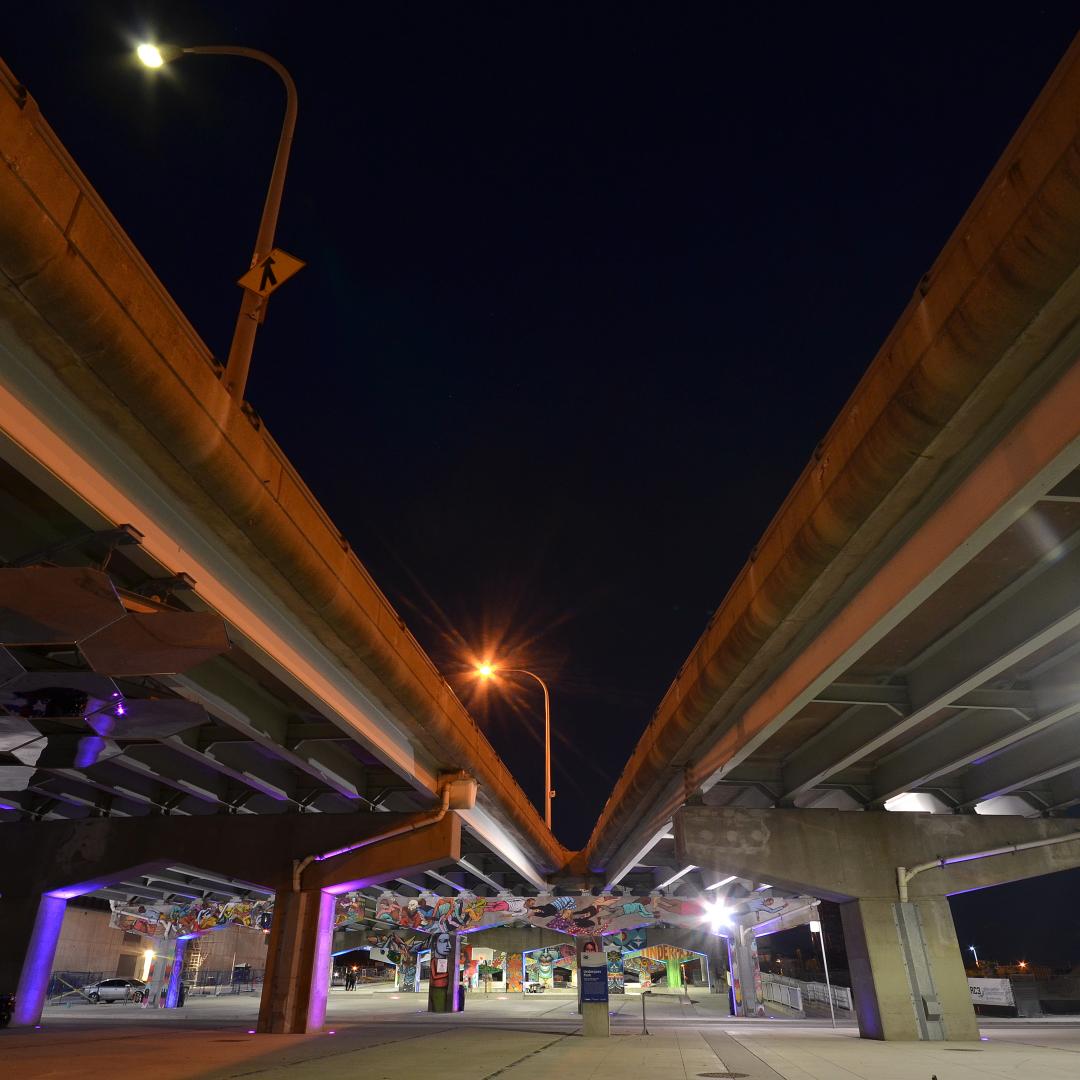 the night sky between two sections of city overpasses