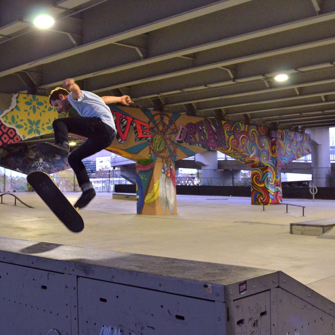 skateboarder using a ramp in an outdoor urban park