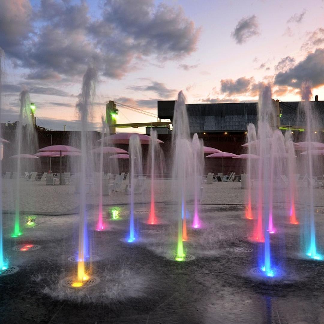 colourful lights of a splashpad at dusk