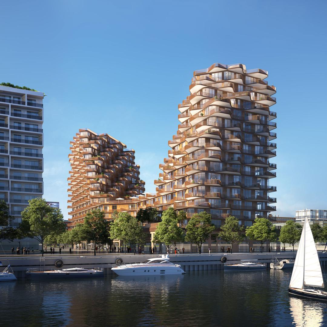 Rendering: a waterfront apartment building with boats in the foreground. 
