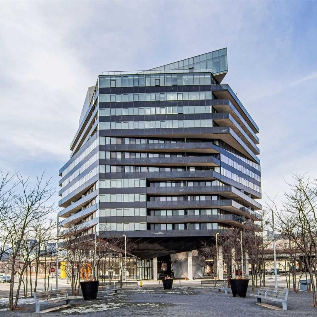 An apartment building with a public realm in front.