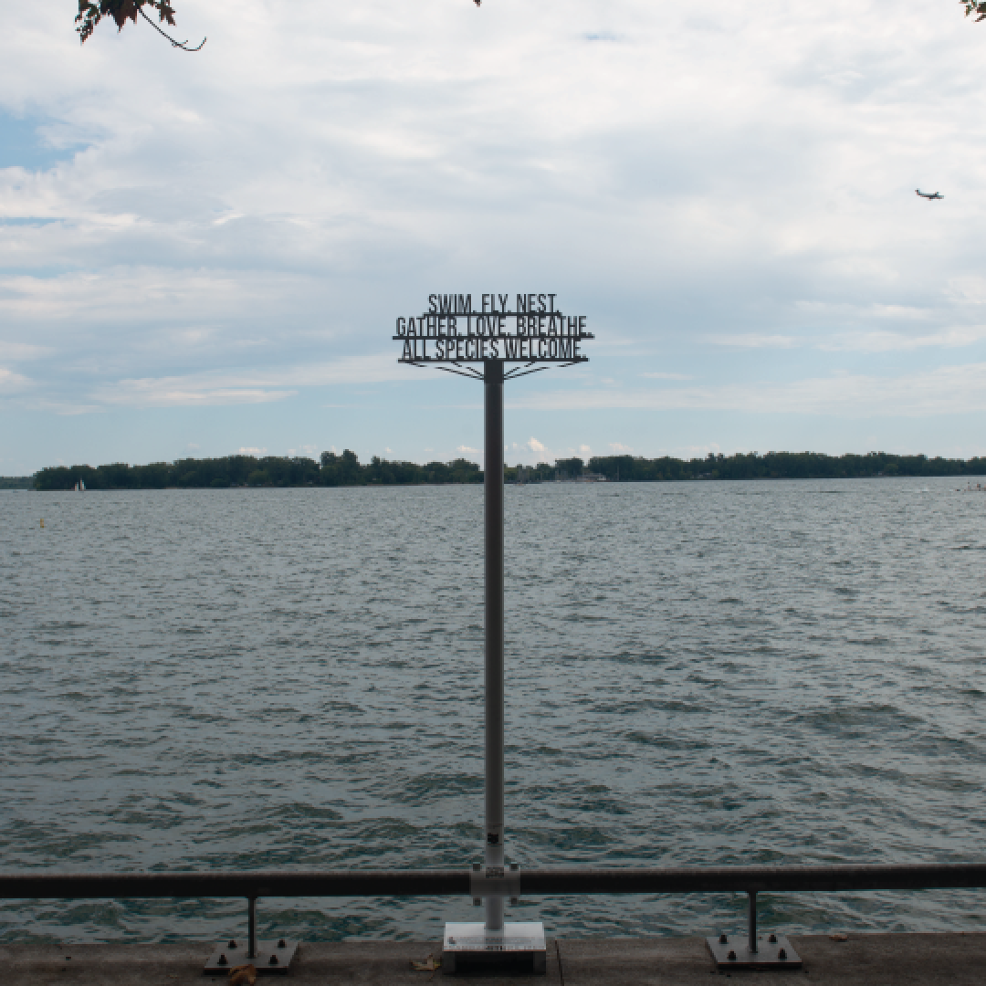 a metal public art installation right at the water's edge