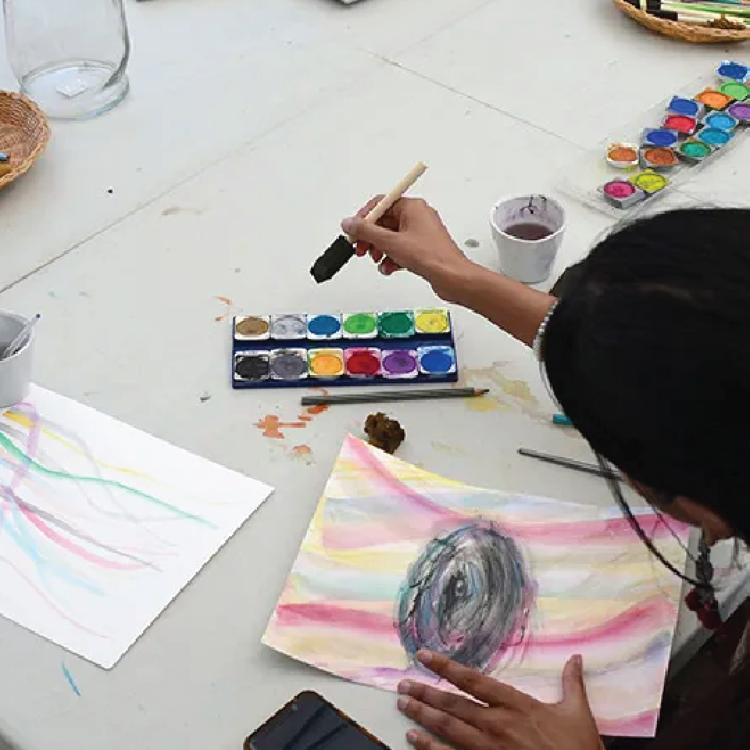 a person painting at a table