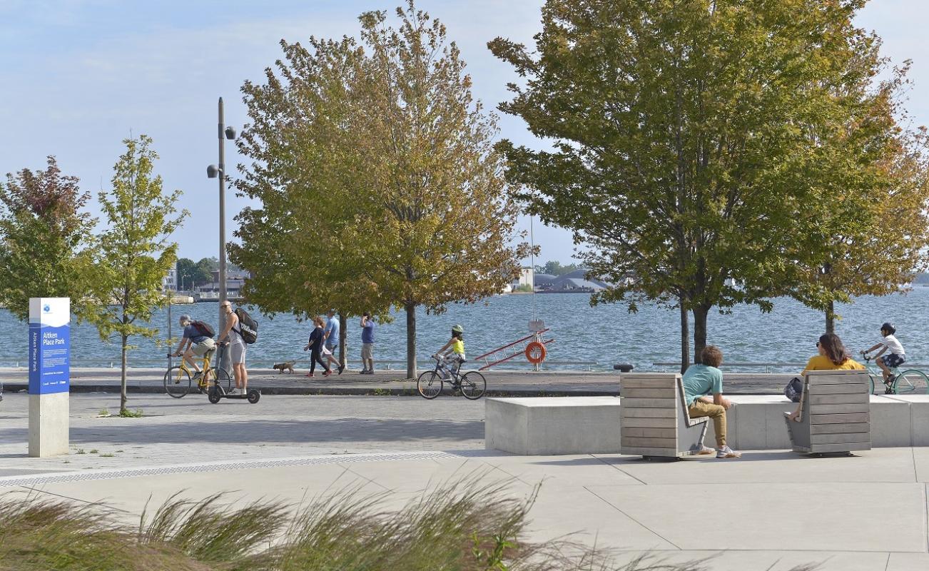 Looking south from Aitken Place Park - a view of trees and Lake Ontario and people enjoying the public space