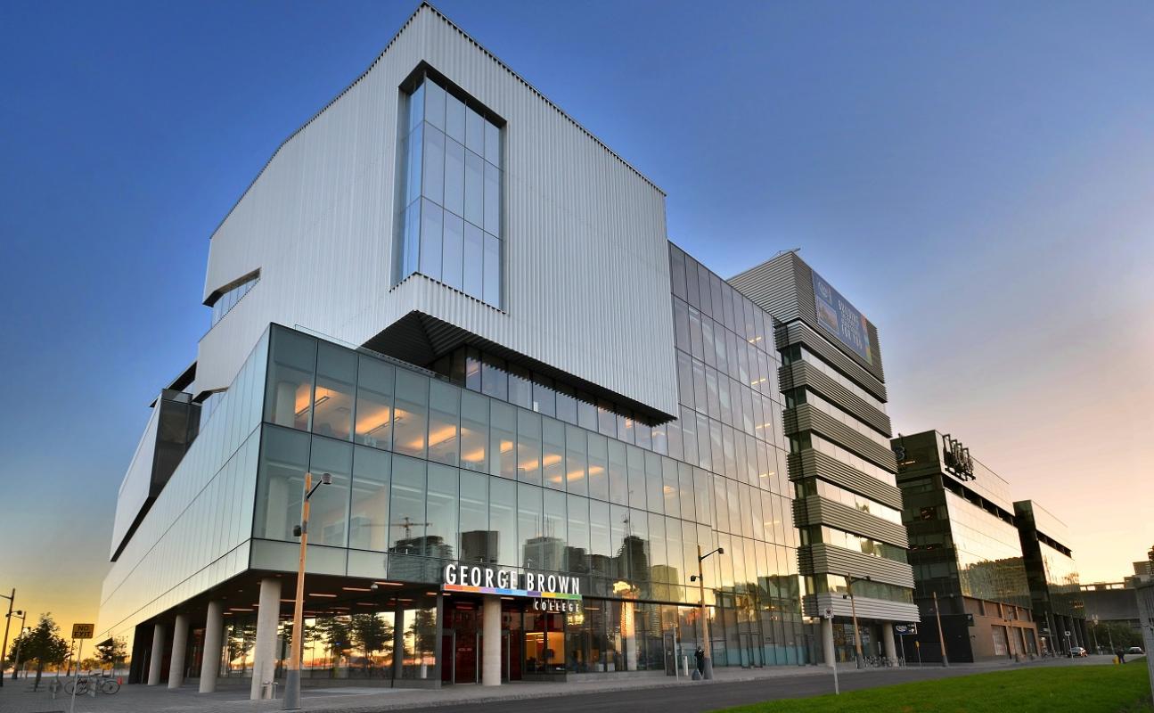 A photo taken at dusk showing the outside of the George Brown College building with the school logo