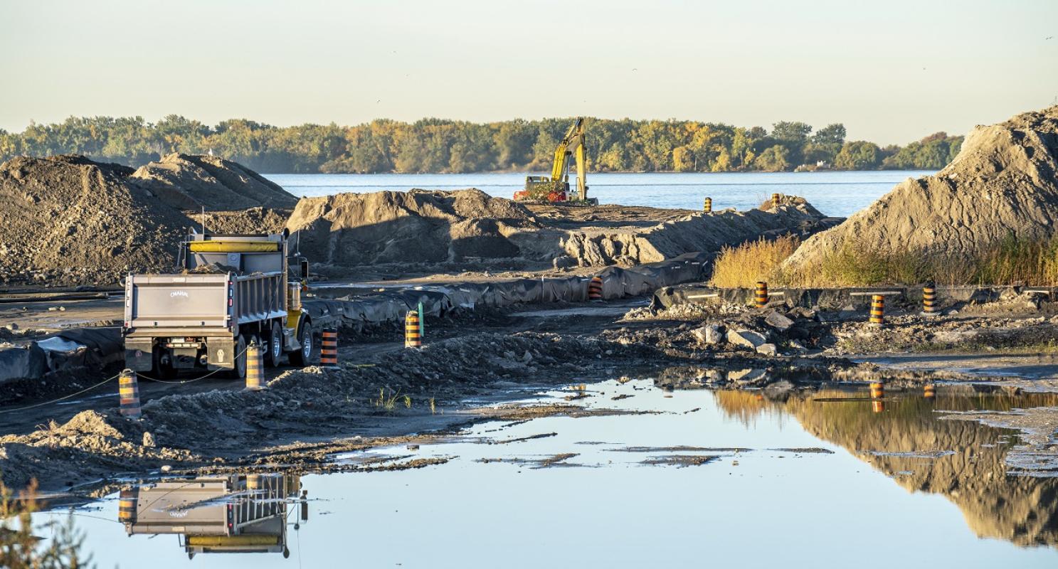 a photo of construction activity and building of a new river with mounds of soil