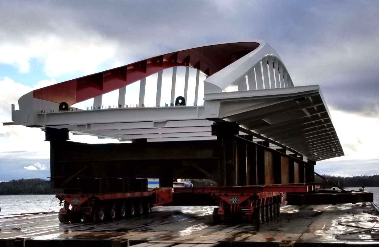 a white and red bridge on a barge