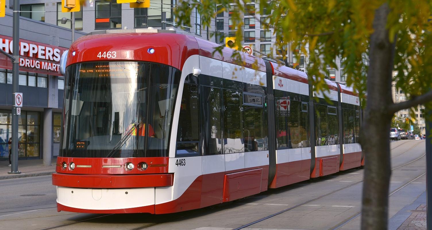 red and white light rail transit at traffic lights