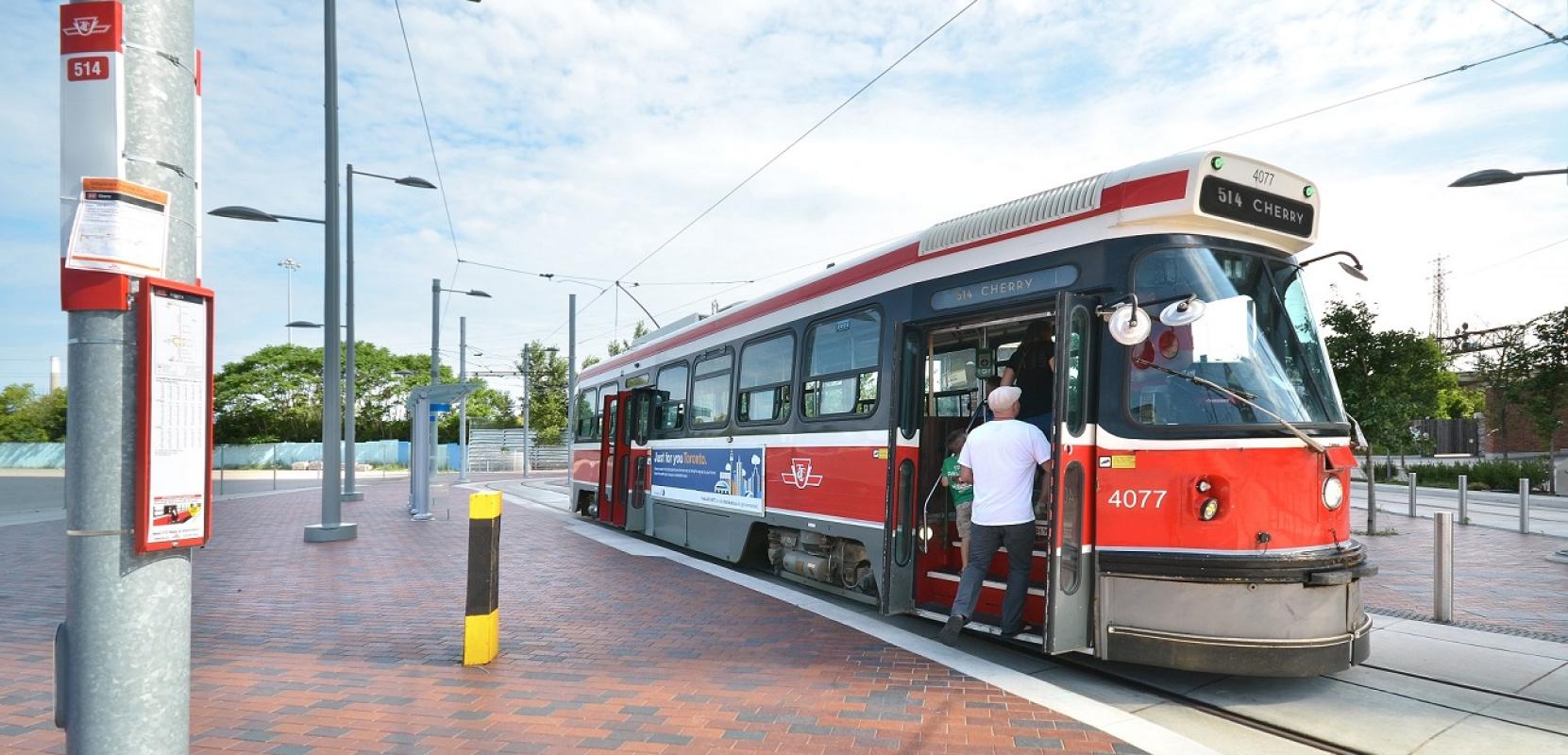 A person stepping onto a streetcar