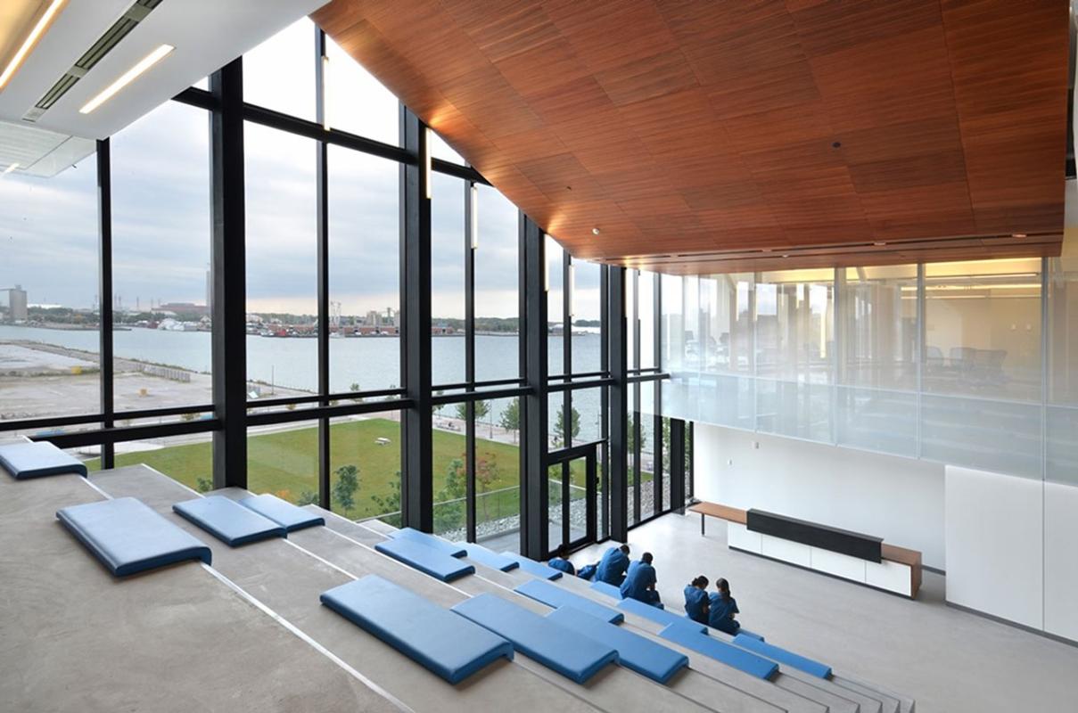 Modern looking college classroom with large windows look out on waterfront. 