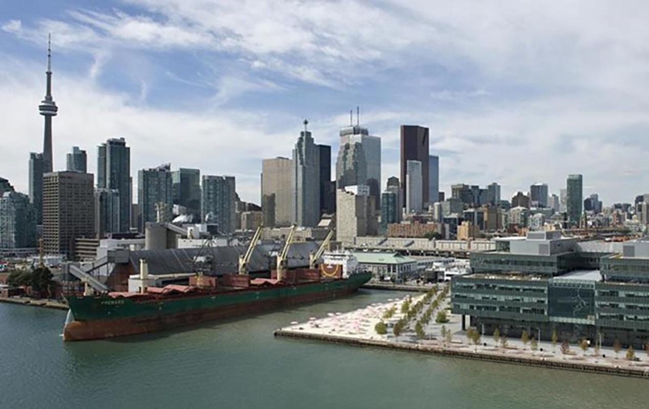 Looking at the waterfront of Toronto with a ship in a port.