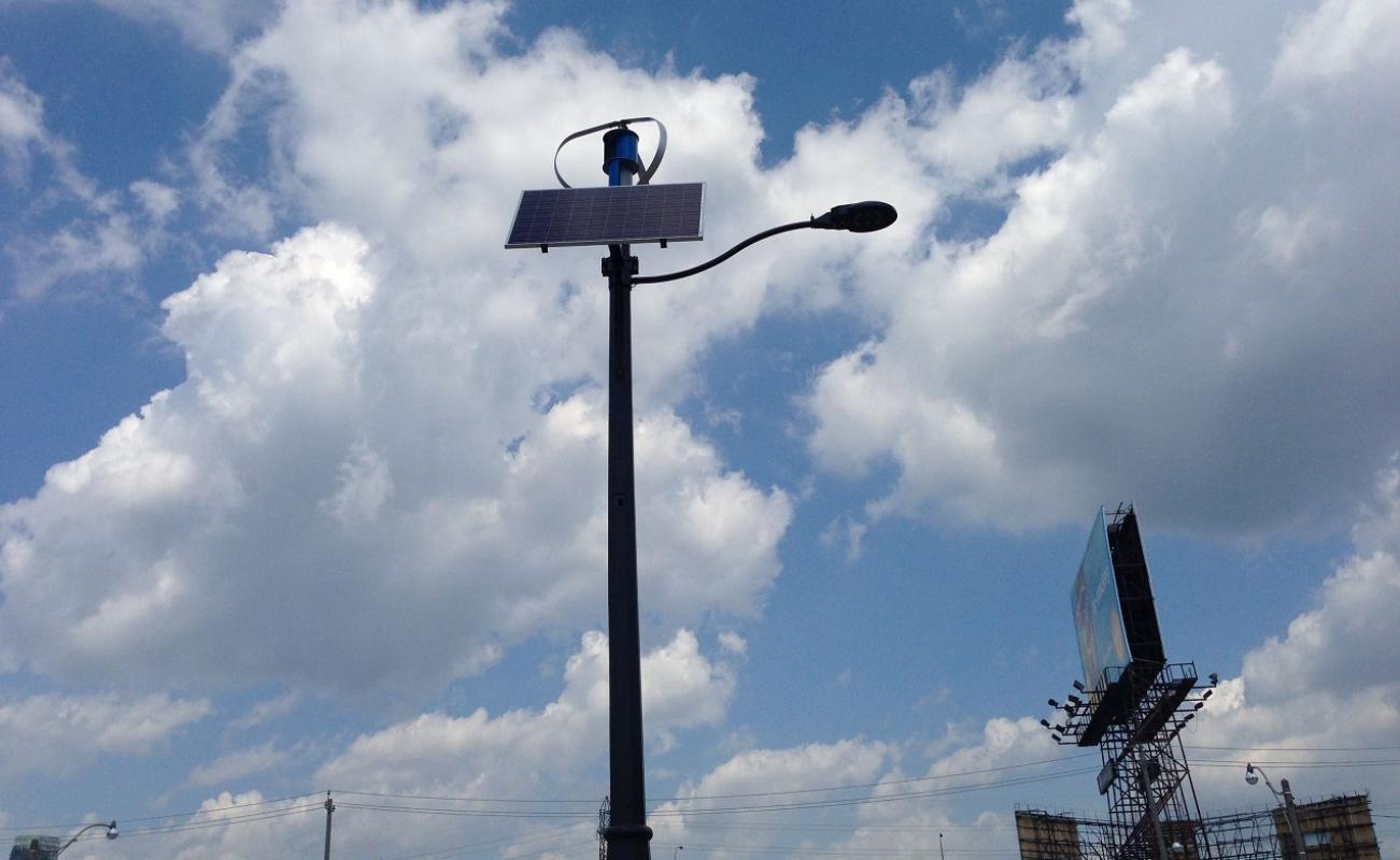 a streetlight with blue sky and white cloud background