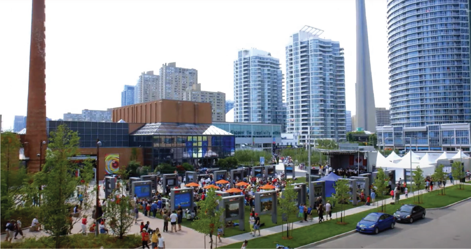 A crowded public plaza in summer. 