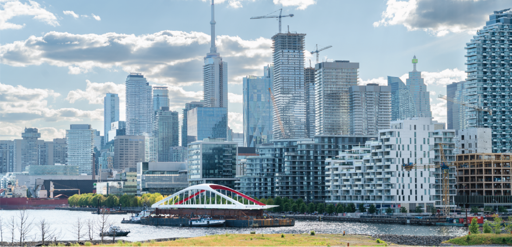 A bridge on a barge with downtown skyline in background. 