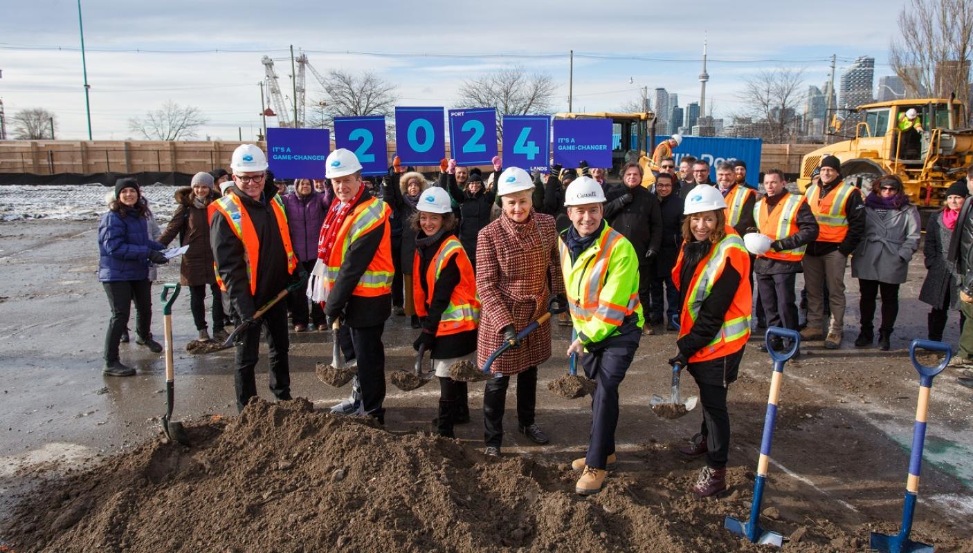 group of people posing for a photo at a groundbreaking event