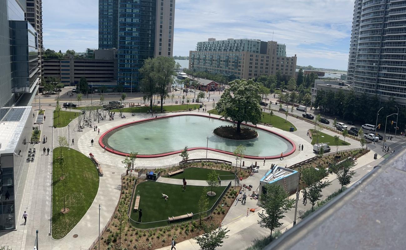 aerial view of an urban park with a large heart shaped pond