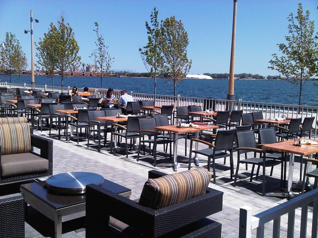 an outdoor patio on the water's edge promenade