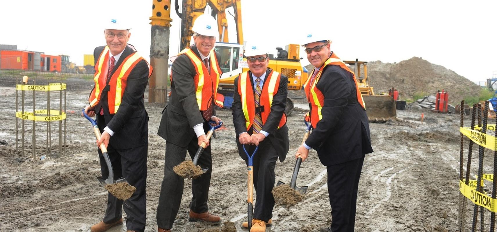 dignitaries posing at a construction groundbreaking event