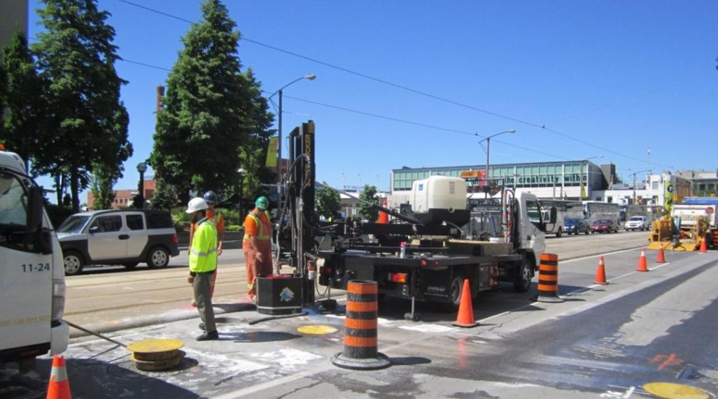 construction crews working with a boring machine on a road