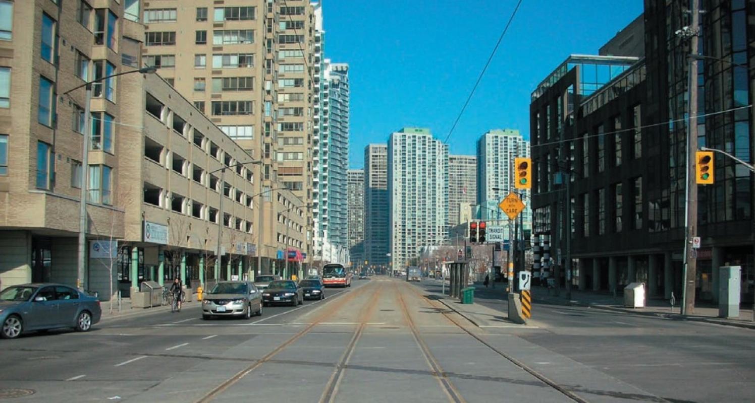 cars driving along a downtown street