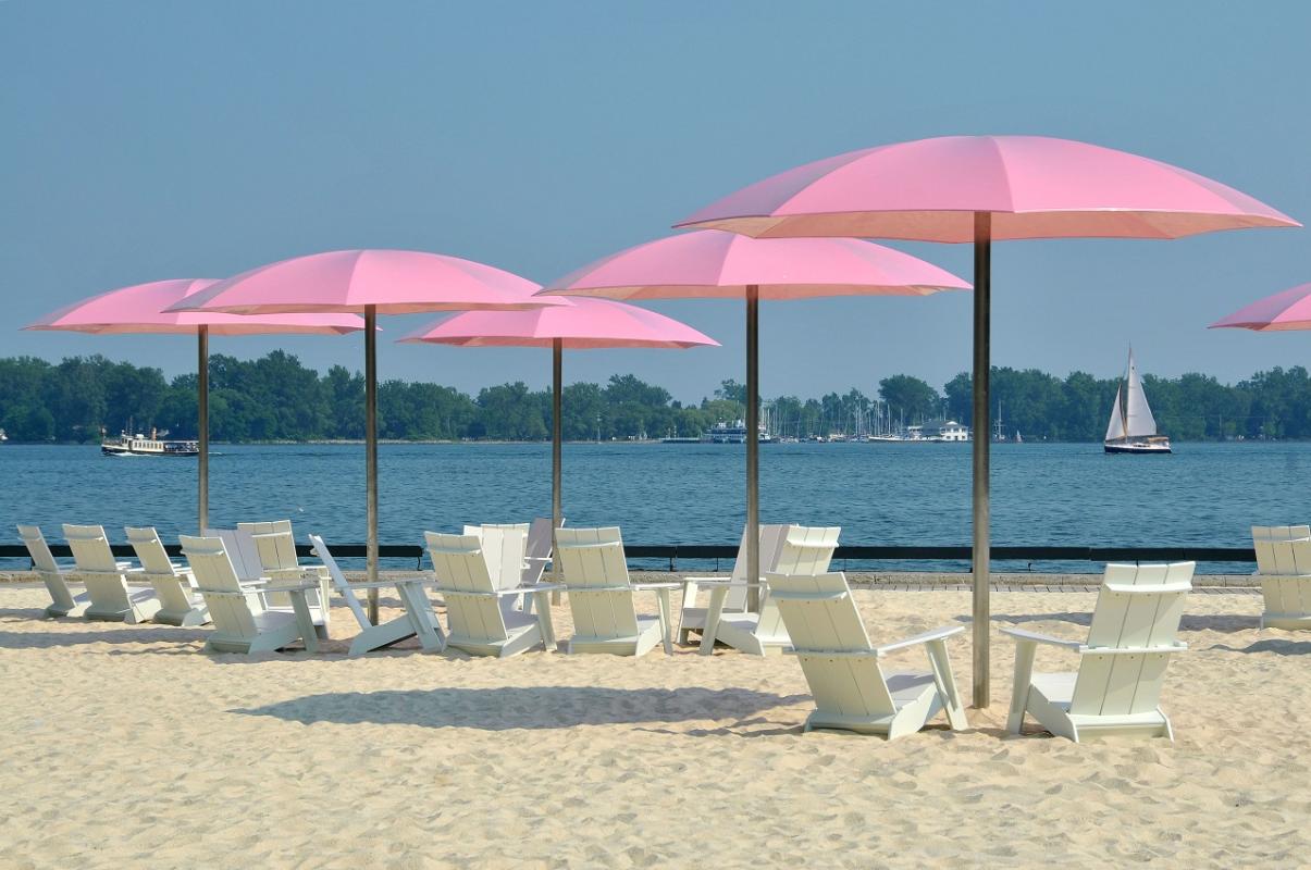 close-up of large pink umbrellas on a beach