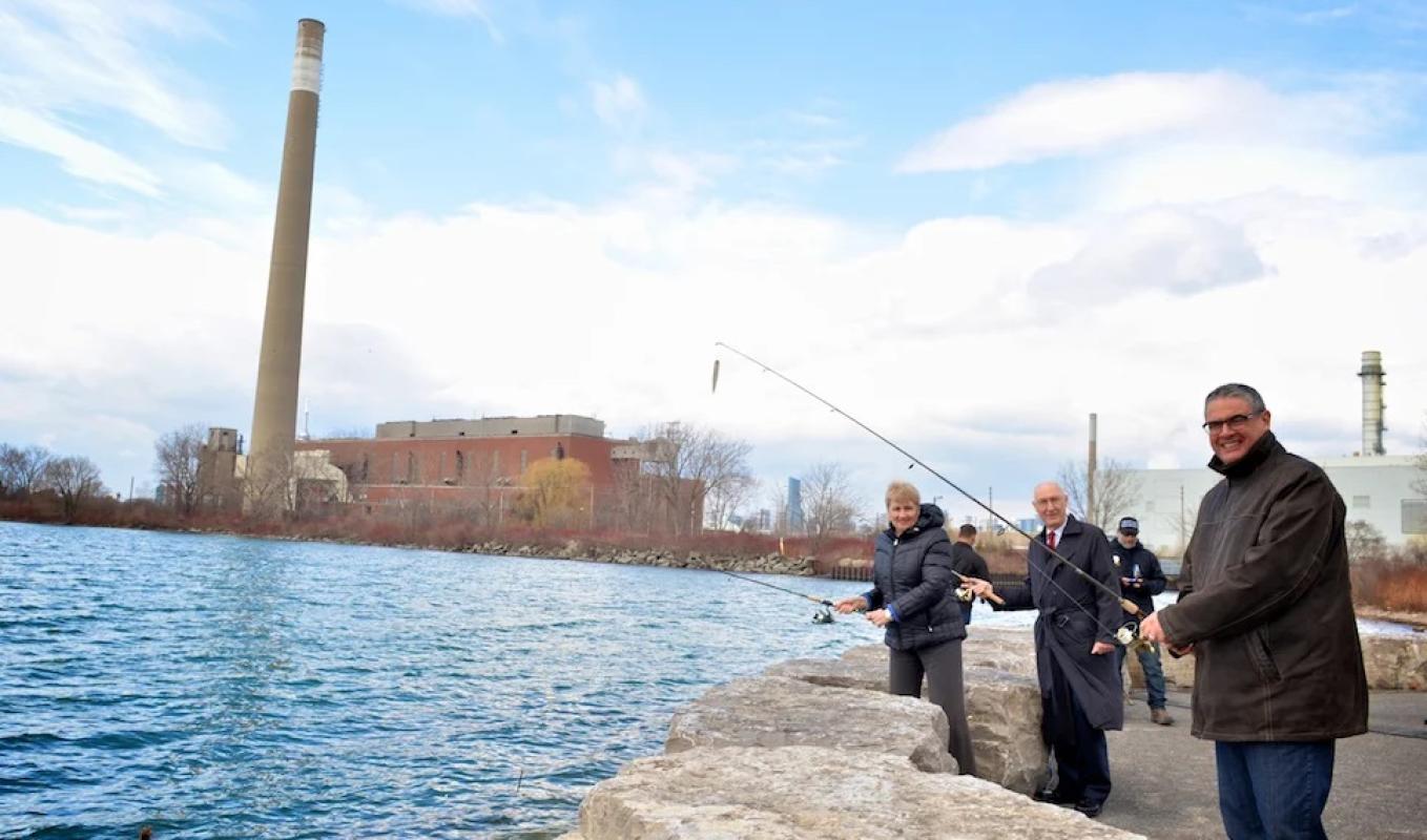 three people casting fishing rods into Lake Ontario