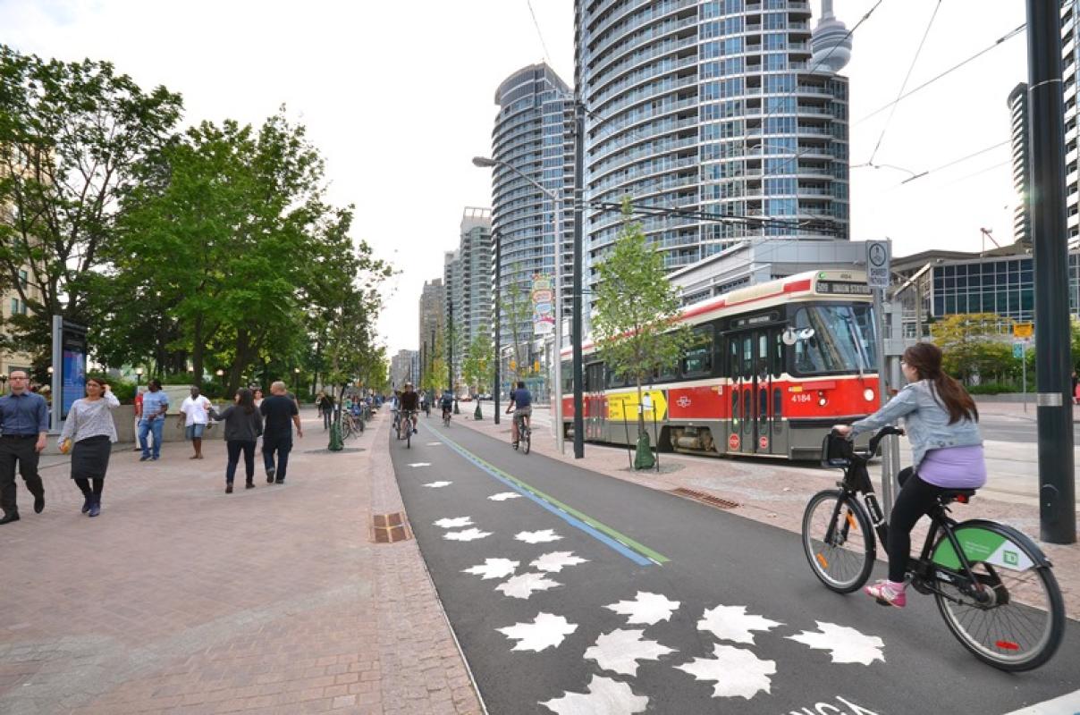 A view of the new extended south side granite promenade, the Martin Goodman Trail and the new streetcar tracks on the revitalized Queens Quay.