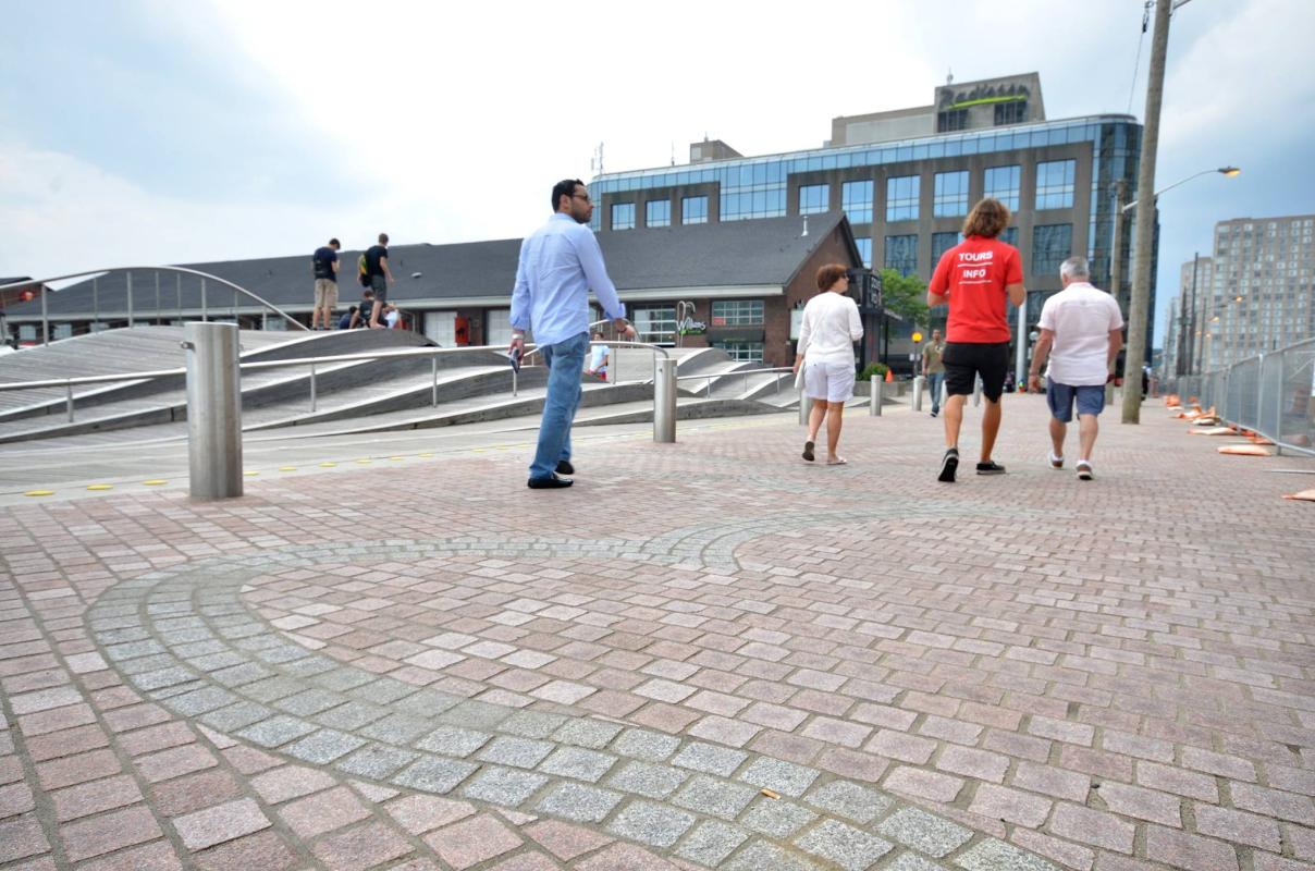 People stroll along a newly-opened section of Queens Quay's promenade near Simcoe WaveDeck