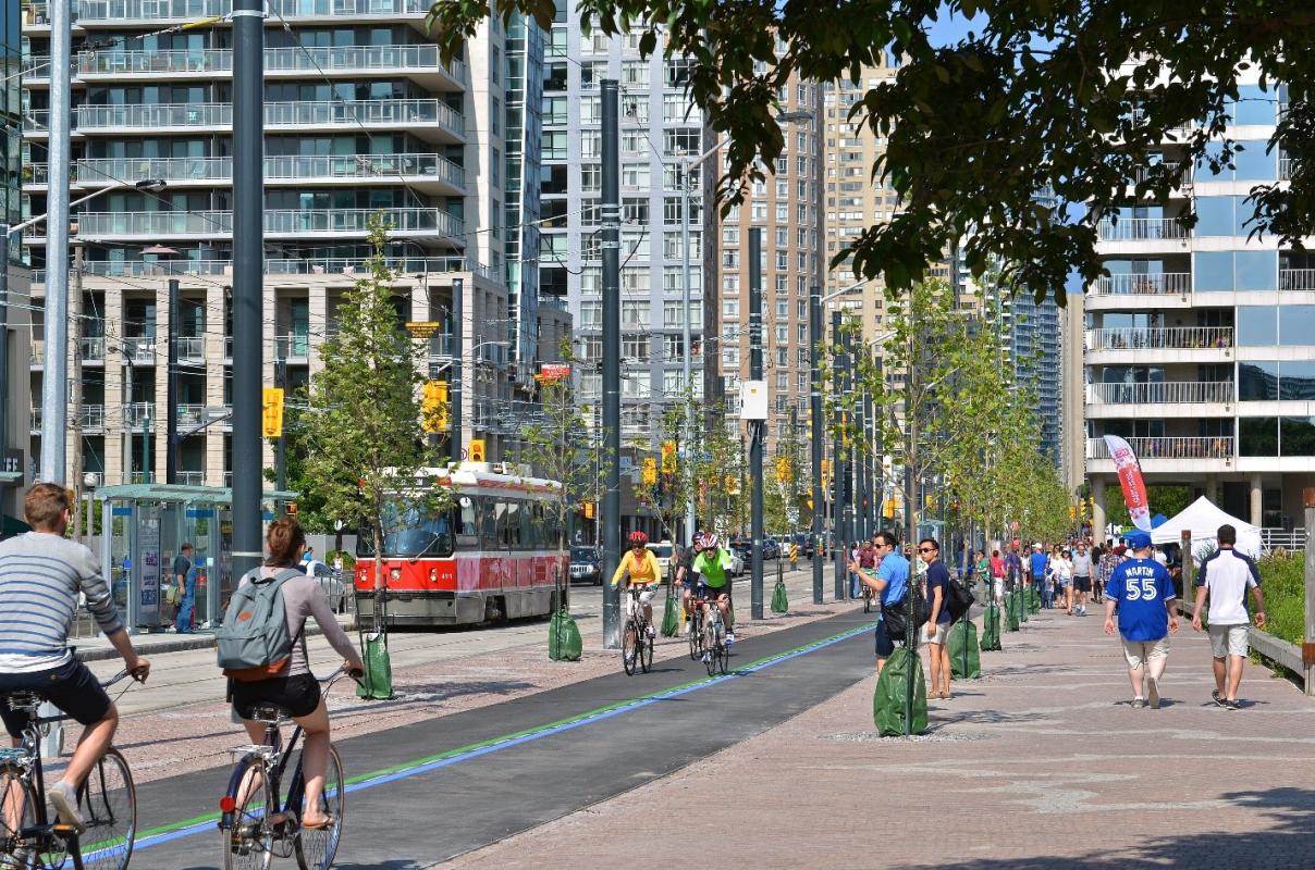 cyclists and pedestrians on the new Queens Quay at Lower Spadina Avenue
