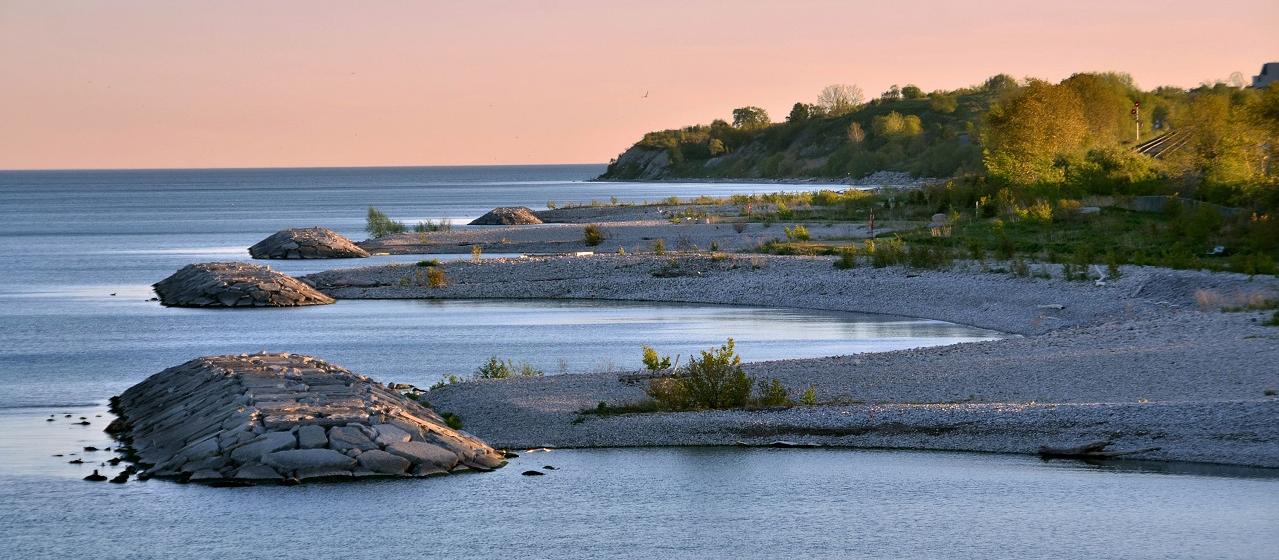A paved waterfront trail along Lake Ontario under open sky