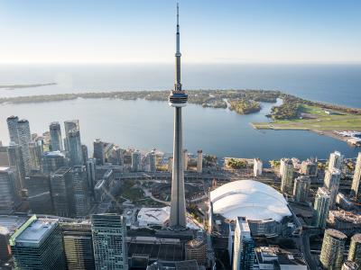 an aerial photo of the waterfront showing the CN Tower, buildings, and the Toronto Islands