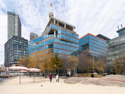 A photo showing the exterior of a building next to an urban beach