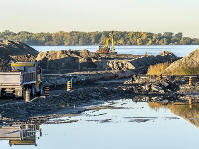 a photo of construction activity and building of a new river with mounds of soil