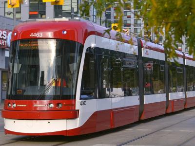 red and white light rail transit at traffic lights