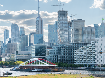 A bridge on a barge with downtown skyline in background.