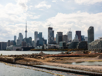 A waterfront construction site with Toronto's skyline in background. 