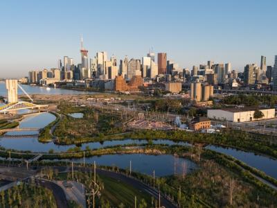 A bird's eye view of Biidaasige Park and Ookwemin Minising with downtown Toronto in the background.