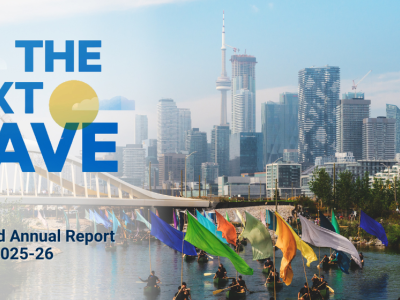 Canoes carrying colourful flags traveling under a bridge with the Toronto Skyline in the back. Text on the image reads 'The Next Wave, Integrated Annual Report 2025-26'