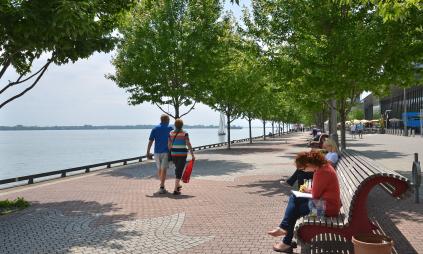 people strolling along the water's edge promenade