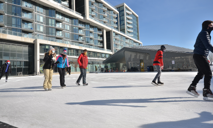 people skating on an outdoor rink in the winter