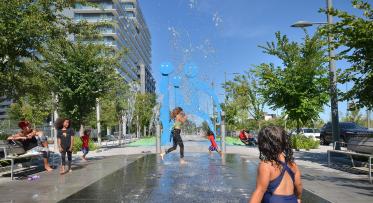 children running through a splash pad