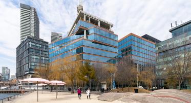 A photo showing the exterior of a building next to an urban beach