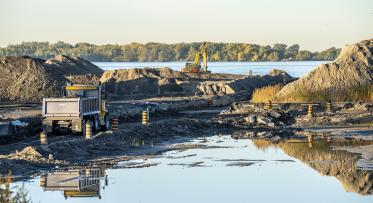 a photo of construction activity and building of a new river with mounds of soil