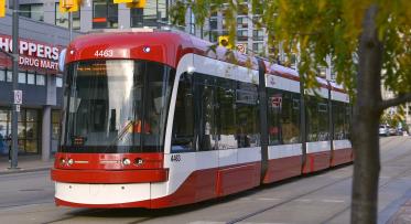 red and white light rail transit at traffic lights