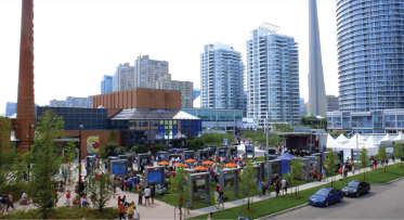 A crowded public plaza in summer. 