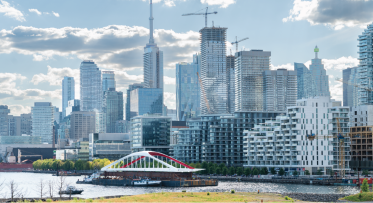 A bridge on a barge with downtown skyline in background. 
