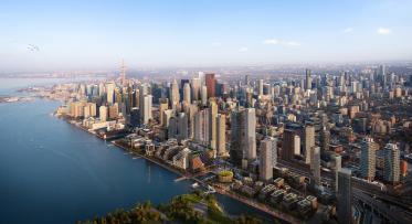 Aerial view of Toronto skyline with CN Tower, along Lake Ontario on a clear day.